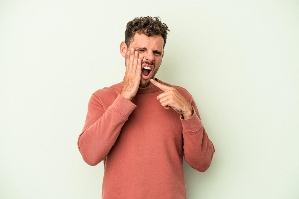 young-caucasian-man-isolated-green-background-having-strong-teeth-pain-molar-ache